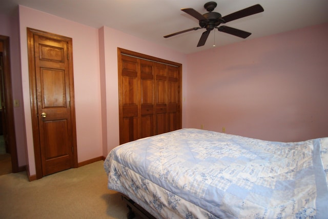 carpeted bedroom with a closet and ceiling fan