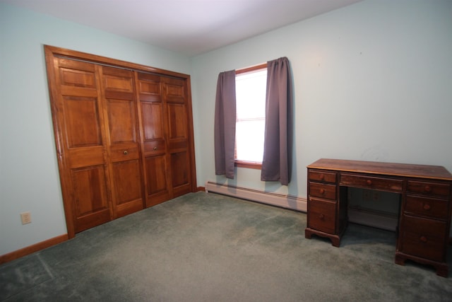 unfurnished office featuring dark colored carpet and baseboard heating