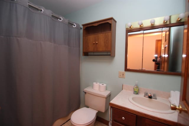 bathroom with walk in shower, vanity, and toilet