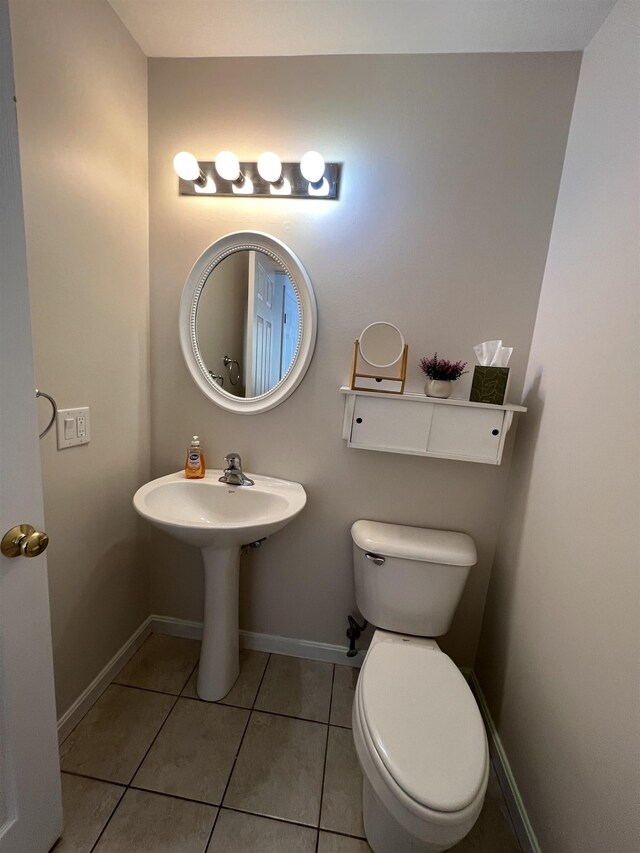 bathroom with tile patterned flooring and toilet