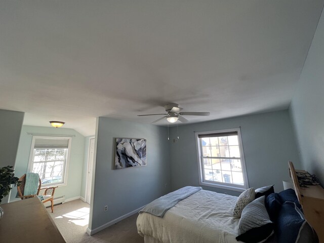 carpeted bedroom featuring baseboard heating and ceiling fan