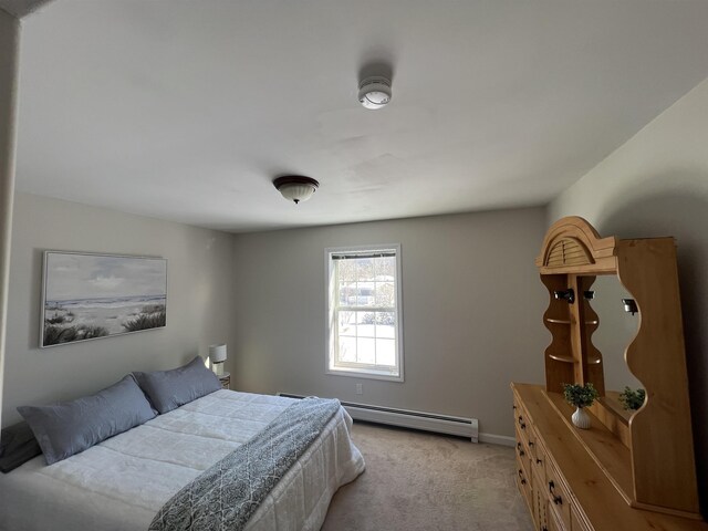 carpeted bedroom featuring baseboard heating