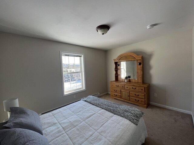 carpeted bedroom featuring baseboard heating