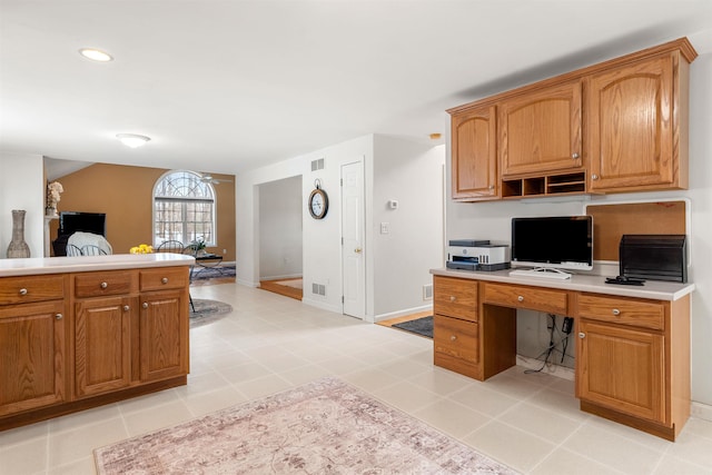 kitchen featuring kitchen peninsula and light tile patterned flooring