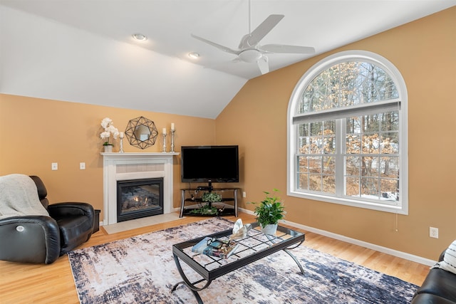 living room with hardwood / wood-style flooring, lofted ceiling, and ceiling fan