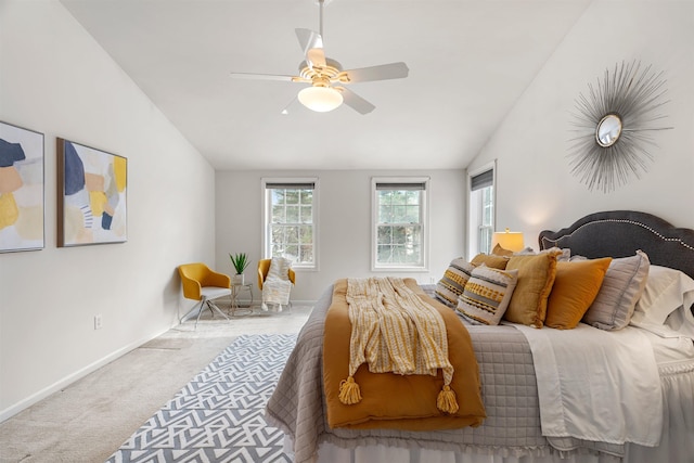 bedroom featuring light carpet, lofted ceiling, and ceiling fan