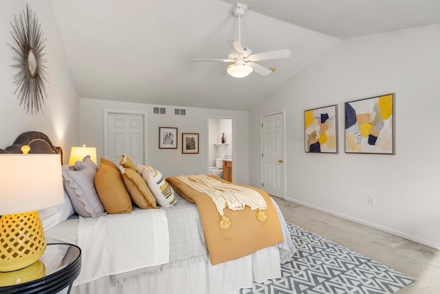 carpeted bedroom featuring ensuite bathroom, lofted ceiling, and ceiling fan