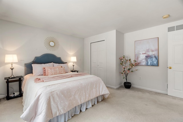 bedroom featuring light colored carpet and a closet