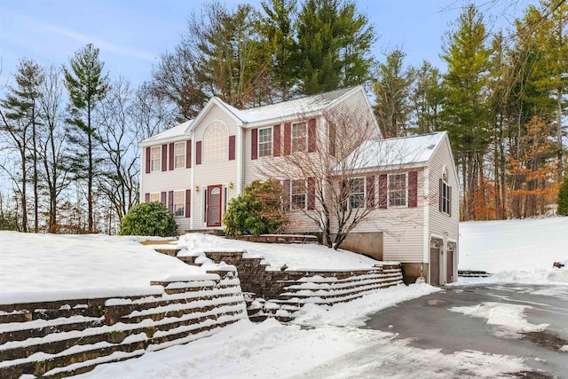 colonial inspired home featuring a garage