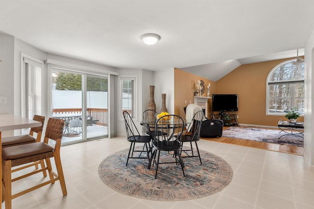 dining area featuring vaulted ceiling