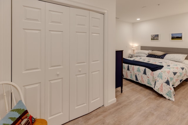 bedroom featuring light hardwood / wood-style flooring and a closet