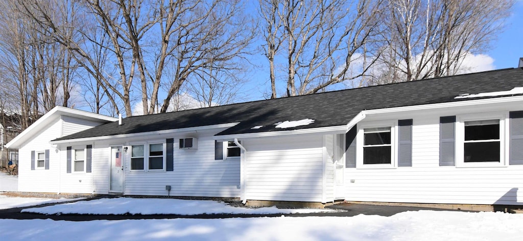 view of snow covered exterior featuring a garage