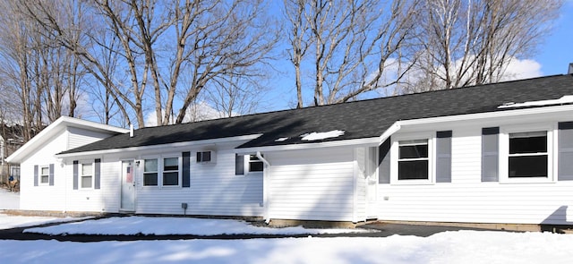 view of snow covered exterior featuring a garage