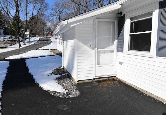 view of snow covered property entrance