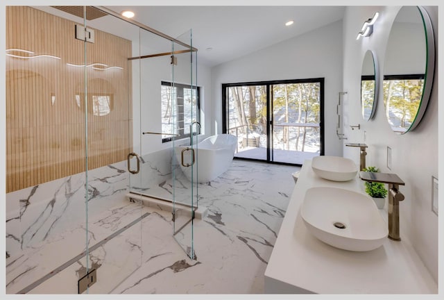 bathroom with lofted ceiling, vanity, and shower with separate bathtub