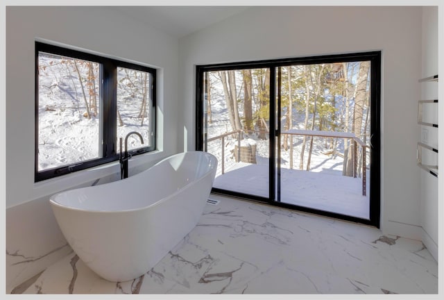 bathroom with a bathing tub and vaulted ceiling