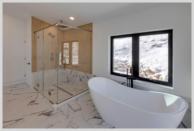 bathroom with a wealth of natural light, shower with separate bathtub, and french doors