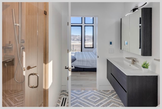 bathroom featuring walk in shower, vanity, and hardwood / wood-style floors