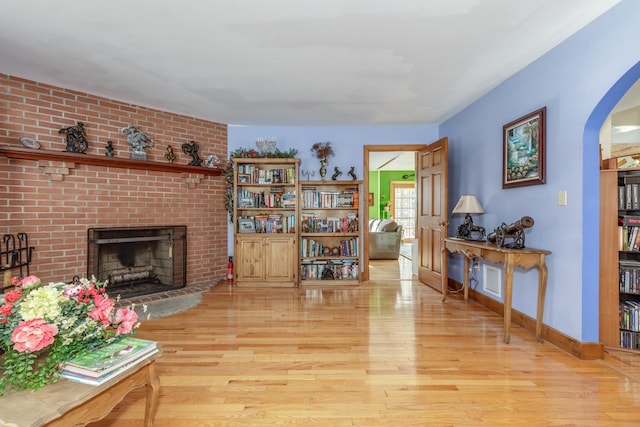 living room with a fireplace and light hardwood / wood-style flooring