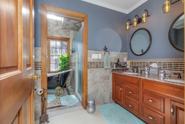 bathroom with crown molding, vanity, and tile walls