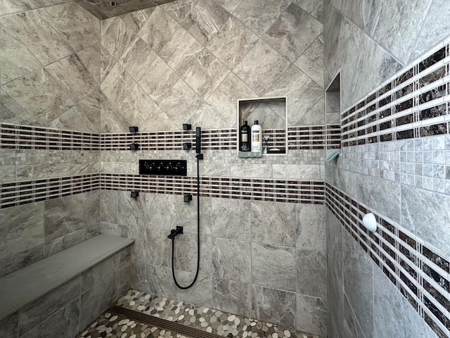 bathroom with tiled shower