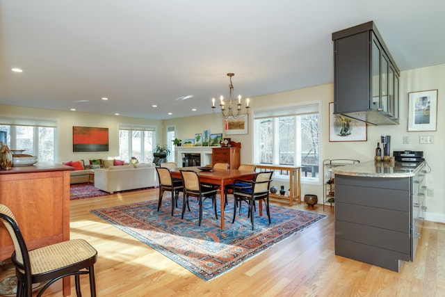 dining area featuring a notable chandelier and light hardwood / wood-style floors