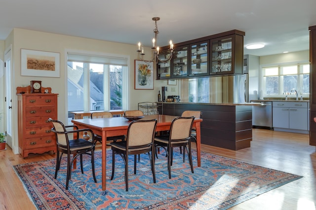 dining room with a chandelier and light hardwood / wood-style floors