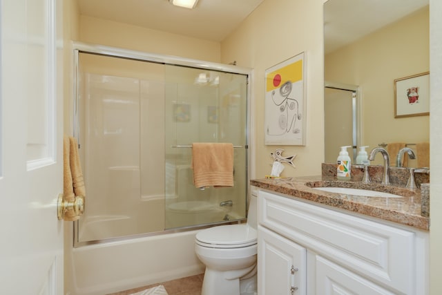 full bathroom featuring enclosed tub / shower combo, vanity, toilet, and tile patterned floors