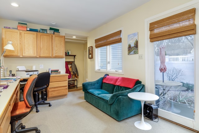 office with built in desk and light colored carpet