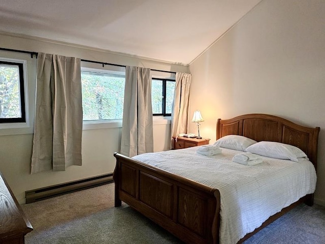 carpeted bedroom with a baseboard heating unit