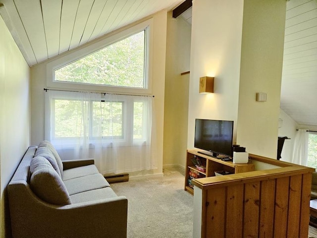 carpeted living room with beamed ceiling and high vaulted ceiling