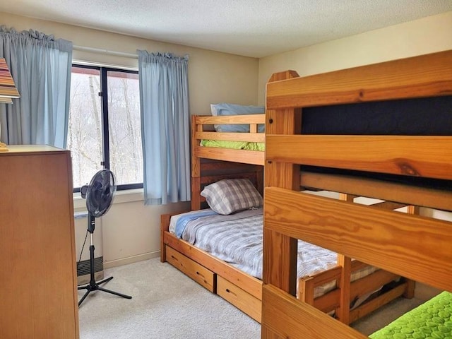 carpeted bedroom featuring multiple windows and a textured ceiling