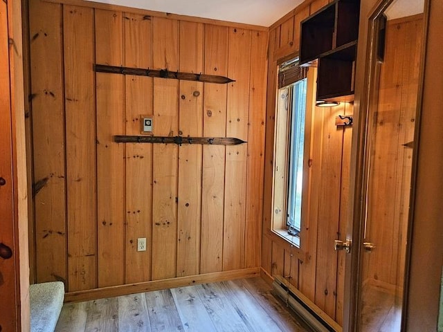 entryway featuring light hardwood / wood-style floors and wood walls