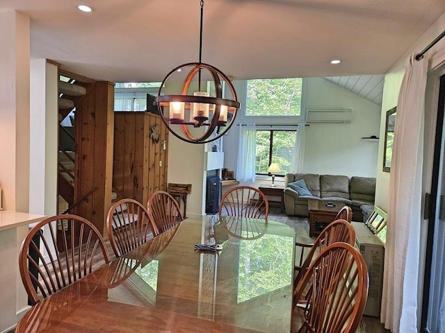 dining area with an inviting chandelier, a wall mounted AC, and vaulted ceiling