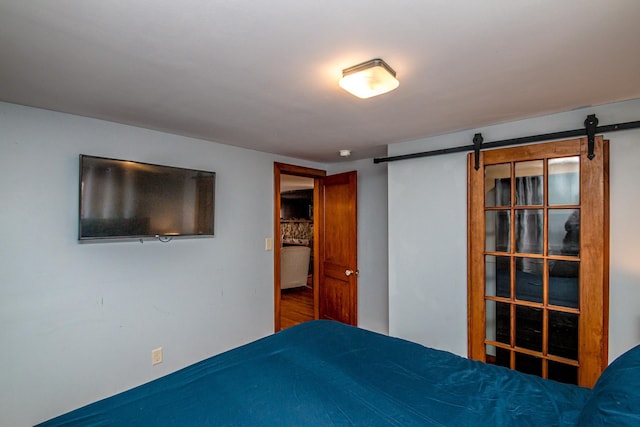 unfurnished bedroom with a barn door