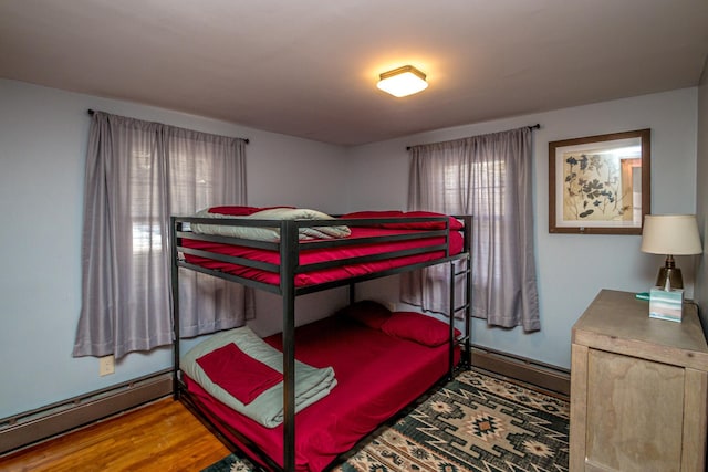 bedroom featuring a baseboard radiator and hardwood / wood-style floors