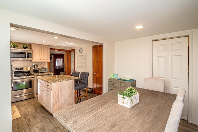 dining area with hardwood / wood-style floors