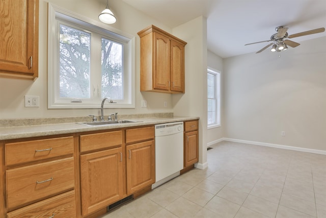 kitchen with sink, light tile patterned floors, plenty of natural light, and dishwasher