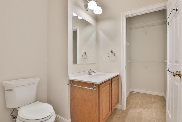 bathroom featuring tile patterned floors, vanity, and toilet