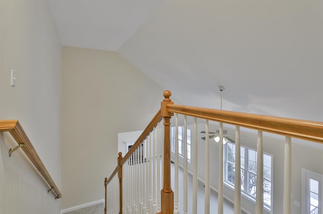 staircase featuring vaulted ceiling and carpet floors