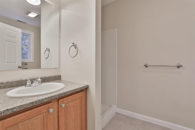 bathroom with tile patterned floors, vanity, and a shower