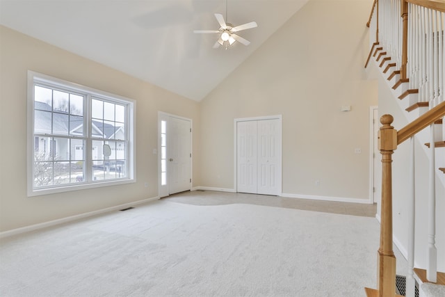 unfurnished living room with ceiling fan, light carpet, and high vaulted ceiling