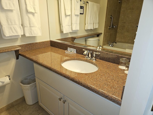 full bathroom featuring vanity, toilet, tile patterned floors, and tiled shower / bath