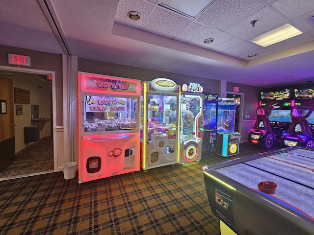 recreation room with a paneled ceiling