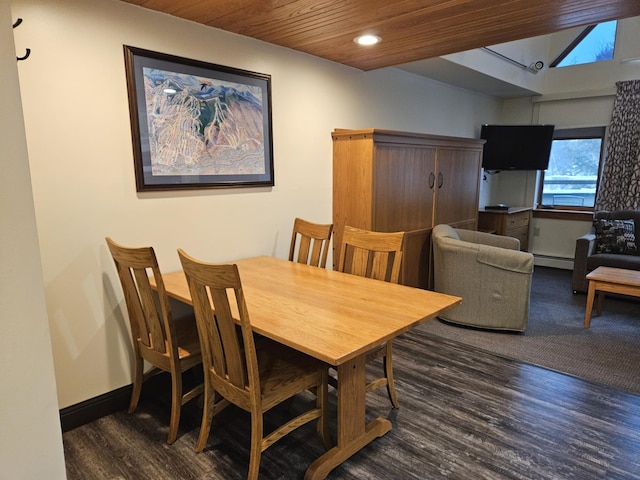 dining area with a baseboard heating unit, wooden ceiling, and dark hardwood / wood-style flooring