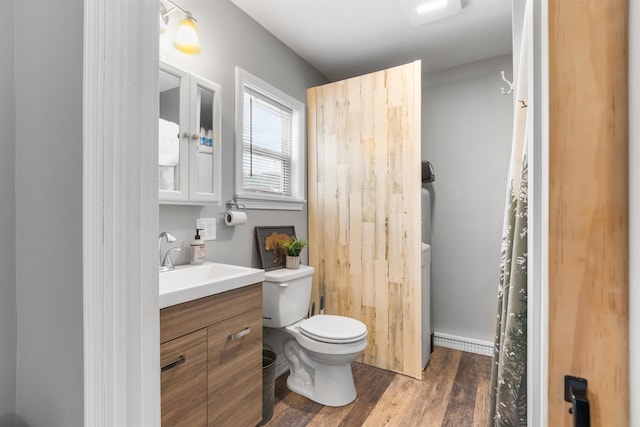 bathroom with vanity, toilet, and wood-type flooring