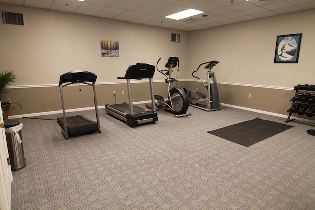 workout area with a drop ceiling and carpet