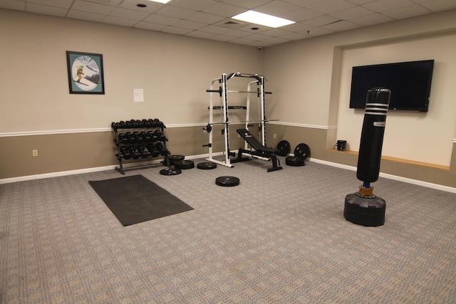 workout room with a paneled ceiling and carpet flooring