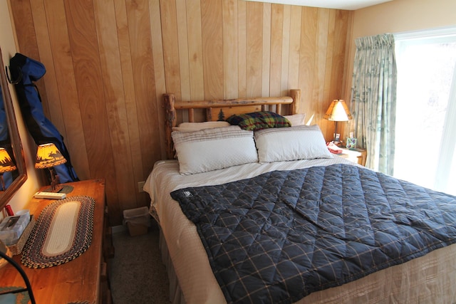 bedroom featuring wooden walls