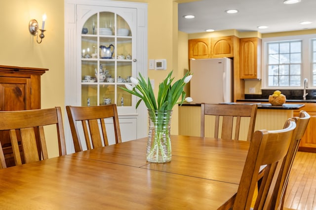 dining room featuring sink and light wood-type flooring